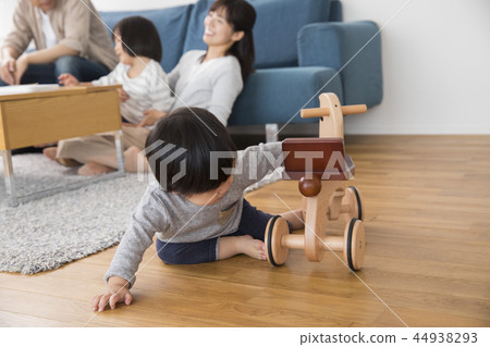 Boy playing with a wooden horse Boy playing with a wooden horse 44938293