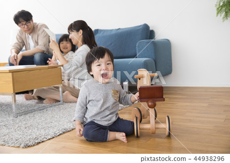 Boy playing with a wooden horse Boy playing with a wooden horse 44938296