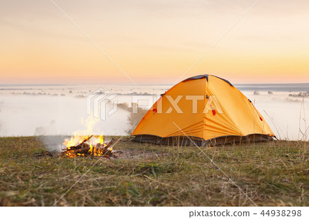 campfire and tent at sunrise campfire and tent at sunrise 44938298