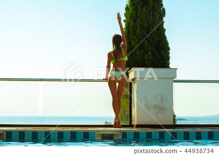 slim girl with a beautiful ass by the pool 44938734