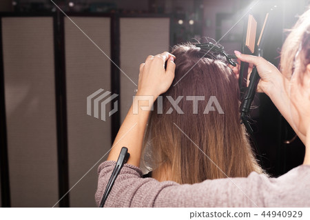 hairdresser making a coiffure to a model 44940929