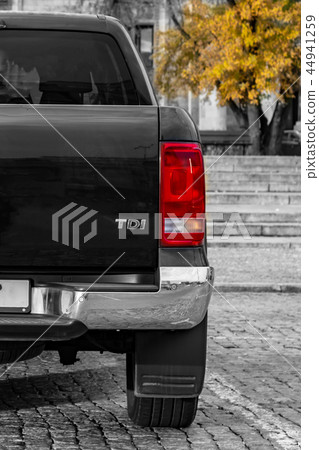 large SUV rear view. against a backdrop of granite steps and wood 44941259