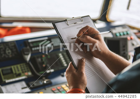 Marine navigational officer or chief mate on navigation watch 44942285