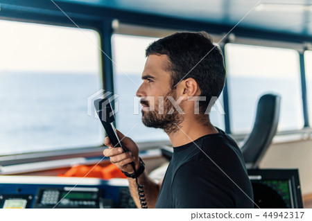 Marine navigational officer is reporting by VHF radio Marine navigational officer is reporting by VHF radio 44942317