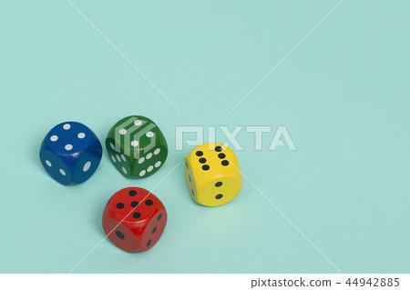Four colorful gaming dices on a blue background 44942885