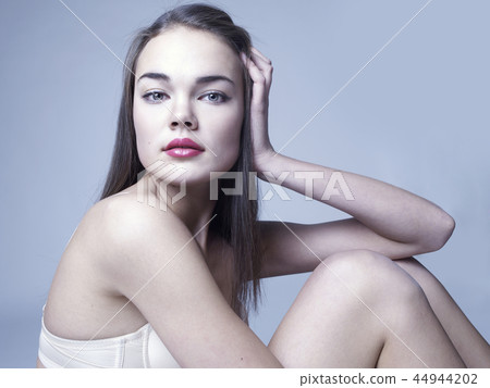 Elegant sitting lady 44944202