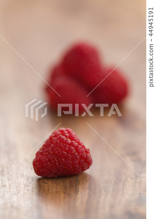 Ripe raspberries on wood background Ripe raspberries on wood background 44945191
