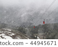 2 red cable carts over the mountain in snow 44945671