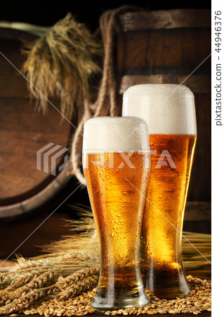 Two mugof beer .With wheat and barley and barrel Two mugof beer .With wheat and barley and barrel 44946376