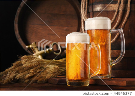 Two mugof beer .With wheat and barley and barrel Two mugof beer .With wheat and barley and barrel 44946377