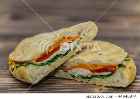 Delicious sandwich with meat and fresh vegetables Delicious sandwich with meat and fresh vegetables 44946974