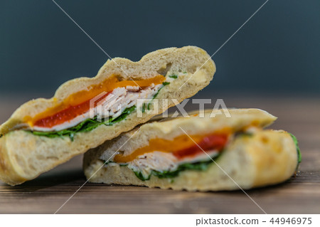 Delicious sandwich with meat and fresh vegetables Delicious sandwich with meat and fresh vegetables 44946975