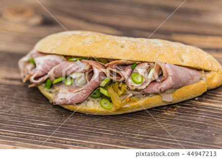Delicious sandwich with meat and fresh vegetables Delicious sandwich with meat and fresh vegetables 44947213