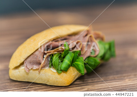 Delicious sandwich with meat and fresh vegetables 44947221