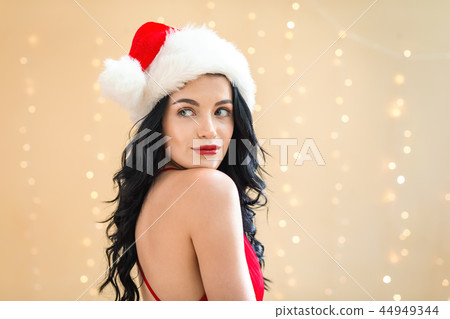 Happy woman with a Santa hat 44949344