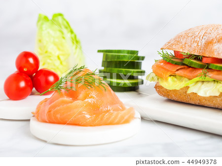 Fresh healthy salmon sandwich with vegetables Fresh healthy salmon sandwich with vegetables 44949378