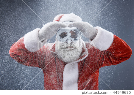 Frozen Santa Claus in protective glasses searching the road 44949650