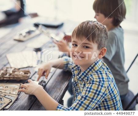 Cute boy sitting next to his brother and smiling to you 44949877