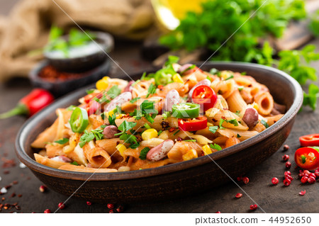 Spicy pasta penne bolognese with vegetables Spicy pasta penne bolognese with vegetables 44952650