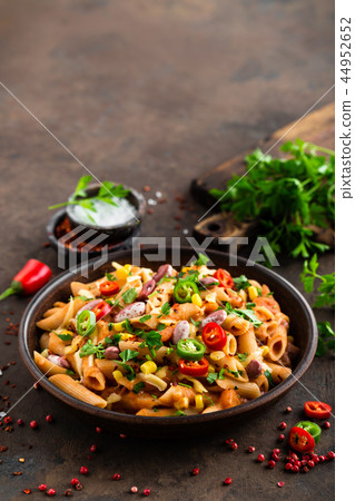 Spicy pasta penne bolognese with vegetables 44952652
