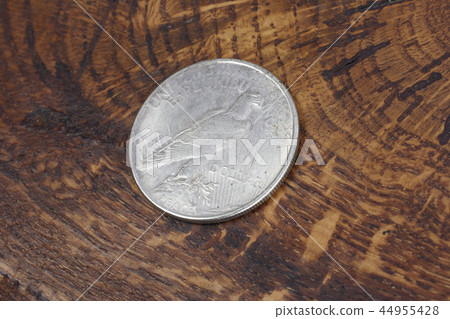 old vintage silver dollar on wooden background 44955428