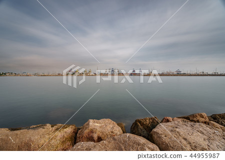 Breakwater, river and commercial port with cranes ultra long exposure Breakwater, river and commercial port with cranes ultra long exposure 44955987