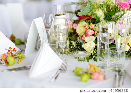 Beautiful table setting with crockery and flowers Beautiful table setting with crockery and flowers 44956288