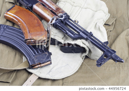 AK47 on USSR Soviet Army khaki uniform background AK47 on USSR Soviet Army khaki uniform background 44956724