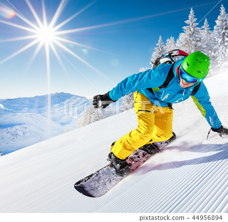 Man snowboarder riding on slope. 44956894