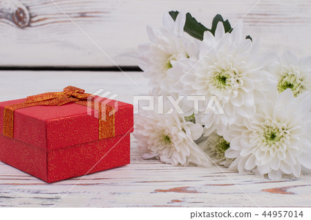 Bouquet of flowers and red gift box. 44957014