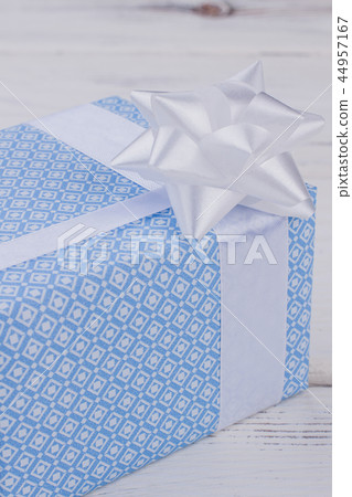 Blue gift box tied with white ribbon. Blue gift box tied with white ribbon. 44957167