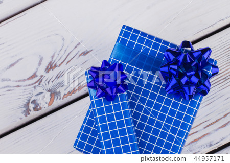 Christmas gift boxes on white wooden background. 44957171