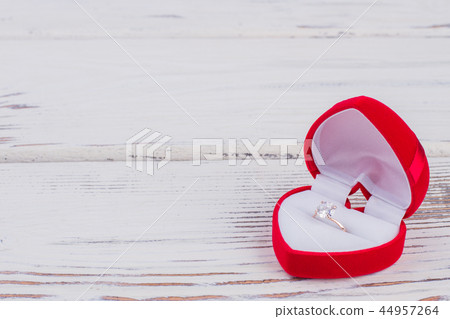 Diamond ring in heart-shaped gift box. Diamond ring in heart-shaped gift box. 44957264