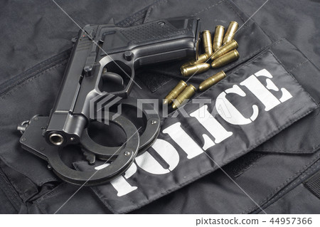 Police concept - handgun on black uniform Police concept - handgun on black uniform 44957366