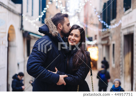 Guy and attractive girl are standing together on street. 44957751