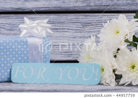 Romantic background with gift and flowers. Romantic background with gift and flowers. 44957759