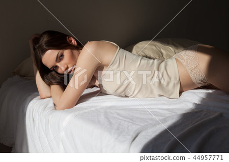 beautiful woman in underwear lies on the bed in the bedroom tonight 44957771