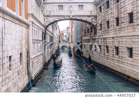 Venetian channel with ancient houses and boats 44957837