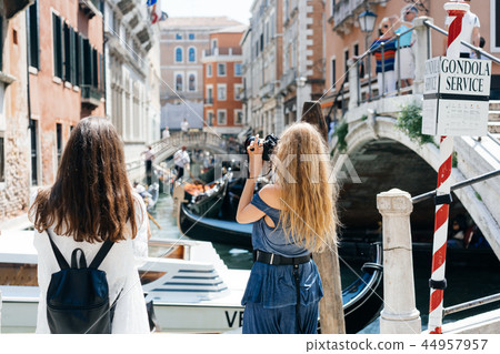 Two young girls stand on the gondola service 44957957