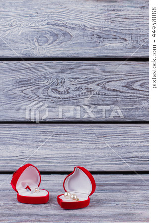 Jewelry in red heart-shaped gift boxes. Jewelry in red heart-shaped gift boxes. 44958088