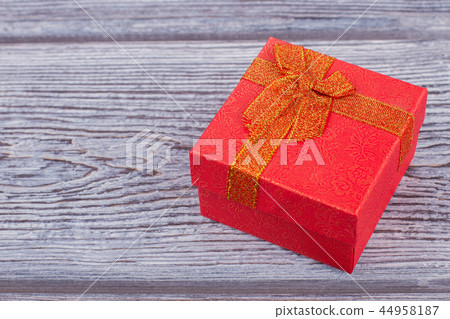Red gift box on wooden background. 44958187