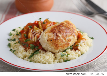 Schnitzel with couscous and vegetables Schnitzel with couscous and vegetables 44958197