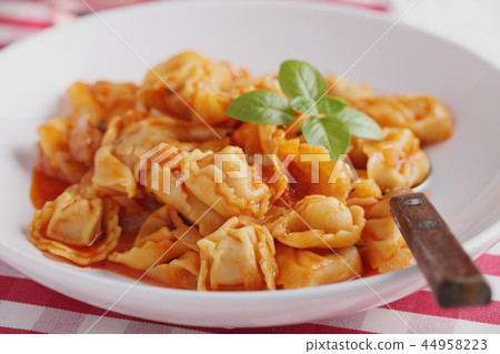 Ravioli under tomato sauce 44958223