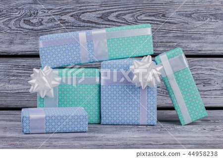 Five wrapped gift boxes on wooden background. 44958238