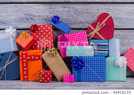 Pile of colorful gift boxes on wooden background. Pile of colorful gift boxes on wooden background. 44958239
