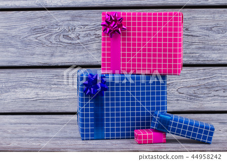 Colorful wrapped gift boxes on wooden background. Colorful wrapped gift boxes on wooden background. 44958242