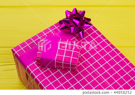 Big and small gift boxes on color background. 44958252