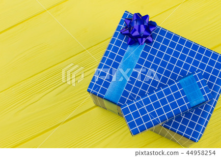 Gift boxes wrapped in dark blue paper. 44958254