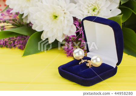 Close up pearl earrings in blue velvet box. 44958280