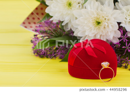 Diamond ring, gift box and flowers. Diamond ring, gift box and flowers. 44958296